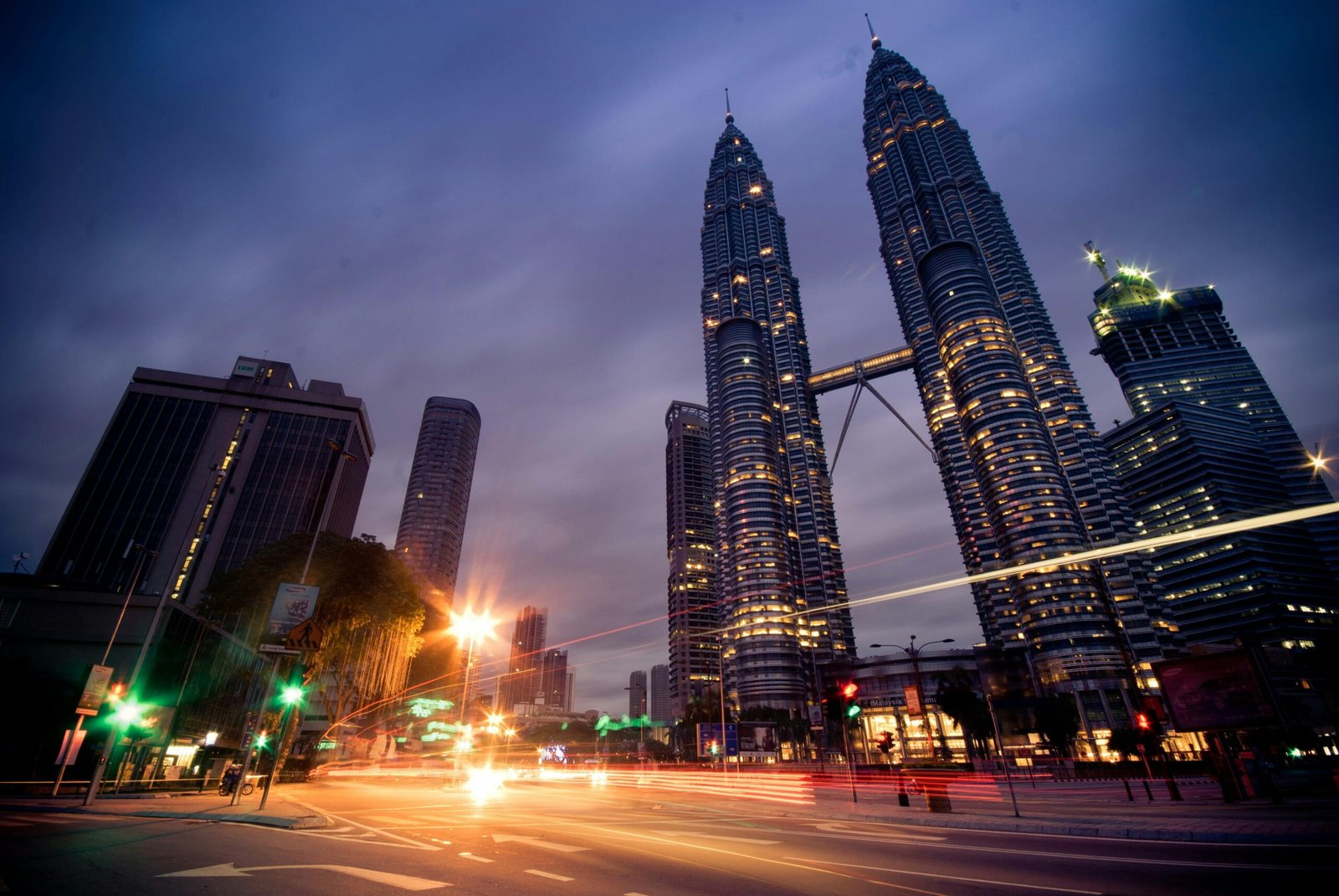 Beautiful long exposure of Kuala Lumpur at night showcasing iconic Petronas Towers and urban lights.